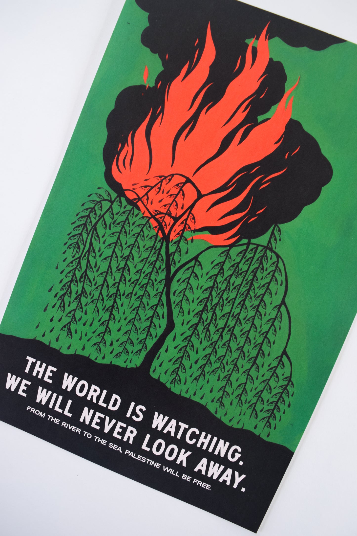 A weeping willow is ablaze with fire and smoke. Each leaf of the tree has been replaced with an eye, and it is accompanied by the words "The World is Watching. We will Never Look Away."