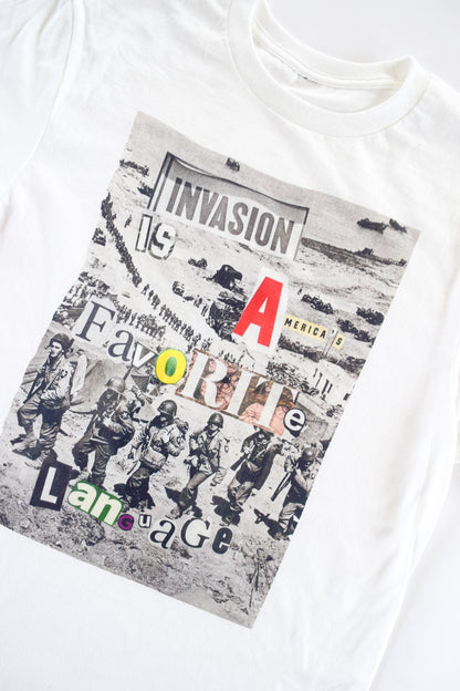 collage artwork with vintage photo of U.S. army forces as background and "Invasion is America's Favorite Language" as collage text overlay, made of cut and pasted magazine materials.