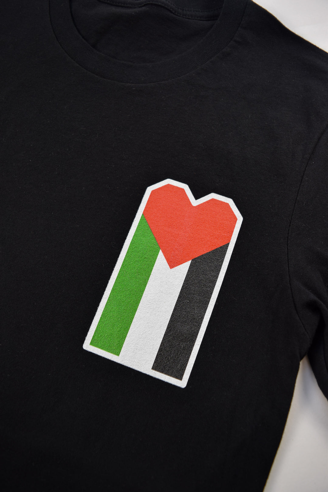 Palestinian flag where the red triangle takes the shape of a heart.